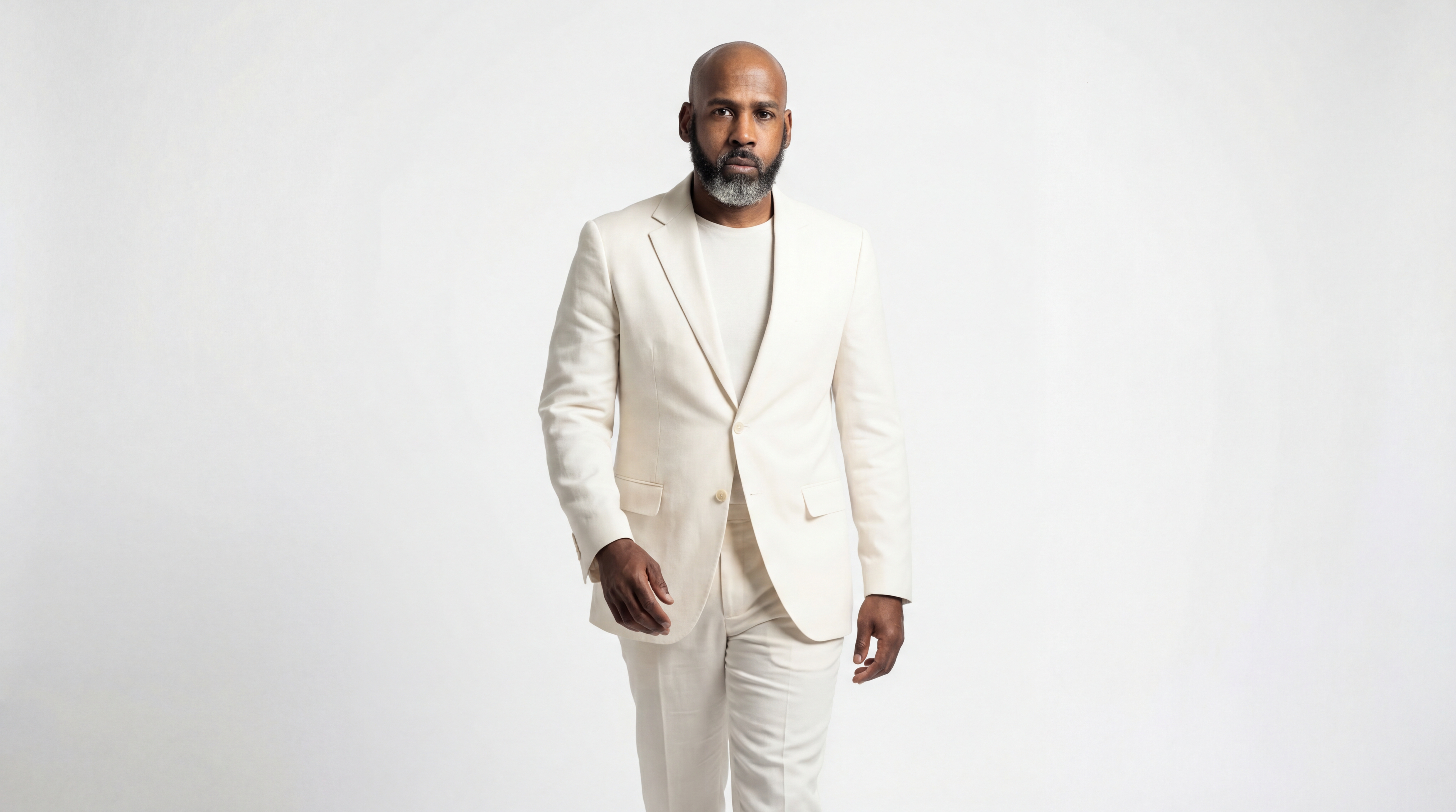 Artist in an off-white suit